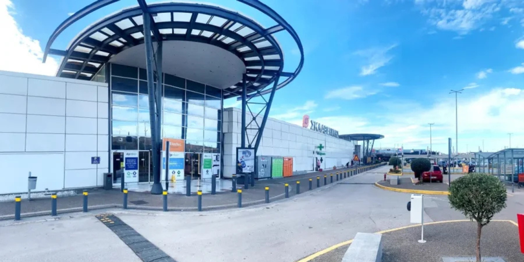 Η εξωτερική είσοδος του εμπορικού κέντρου Patra Mall στην Περιβόλα Πατρών, με το μεγάλο κυκλικό στέγαστρο και τη γυάλινη πρόσοψη.